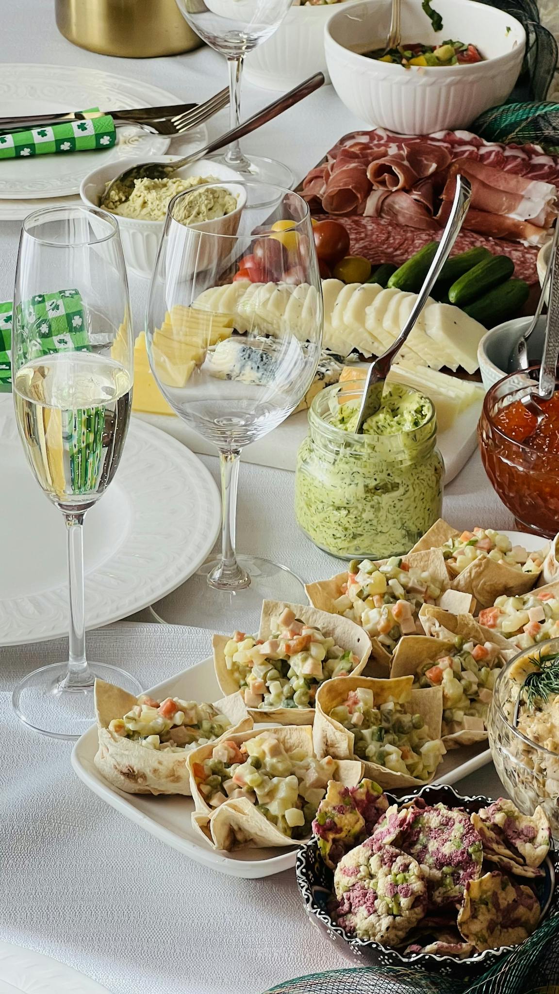 A lavish spread of appetizers and champagne glasses on a buffet table.
